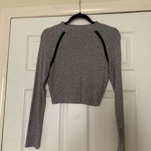 Gray crop top with black accents on the sides
